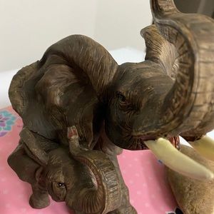 Elephant statue with a baby elephant on the side. Stepping to the beat